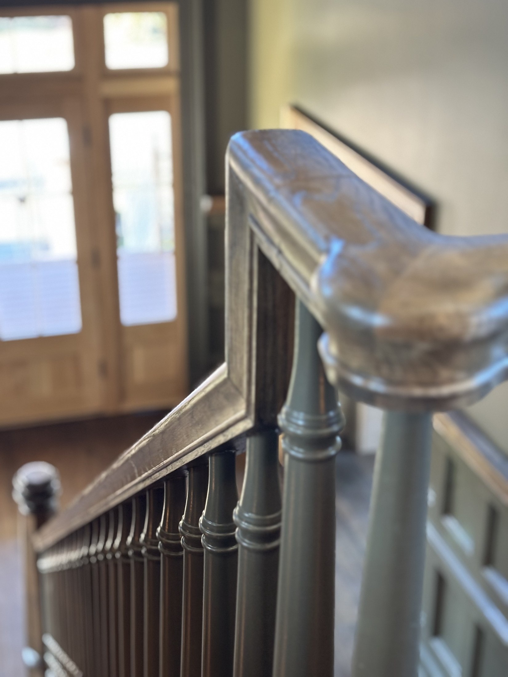 Close-up of a stair handrail turn — wood joinery in finish carpentry