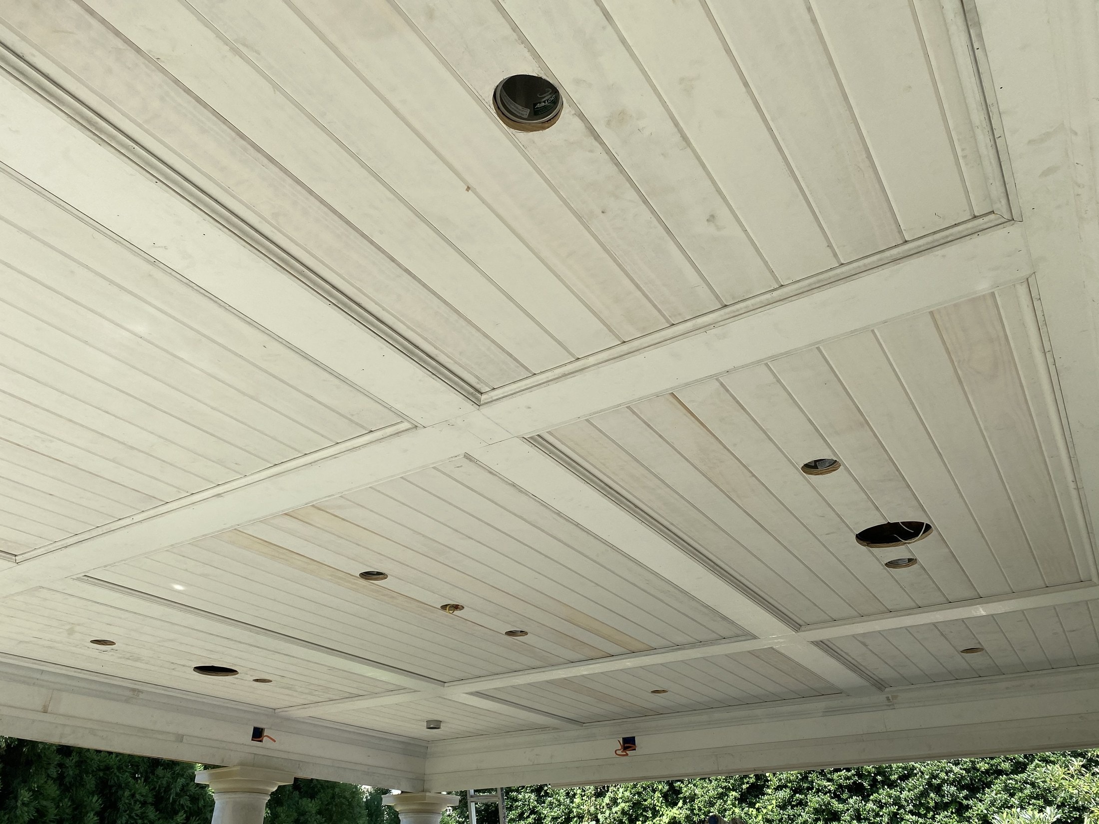 Tongue-and-groove paneled ceiling on a covered porch in progress